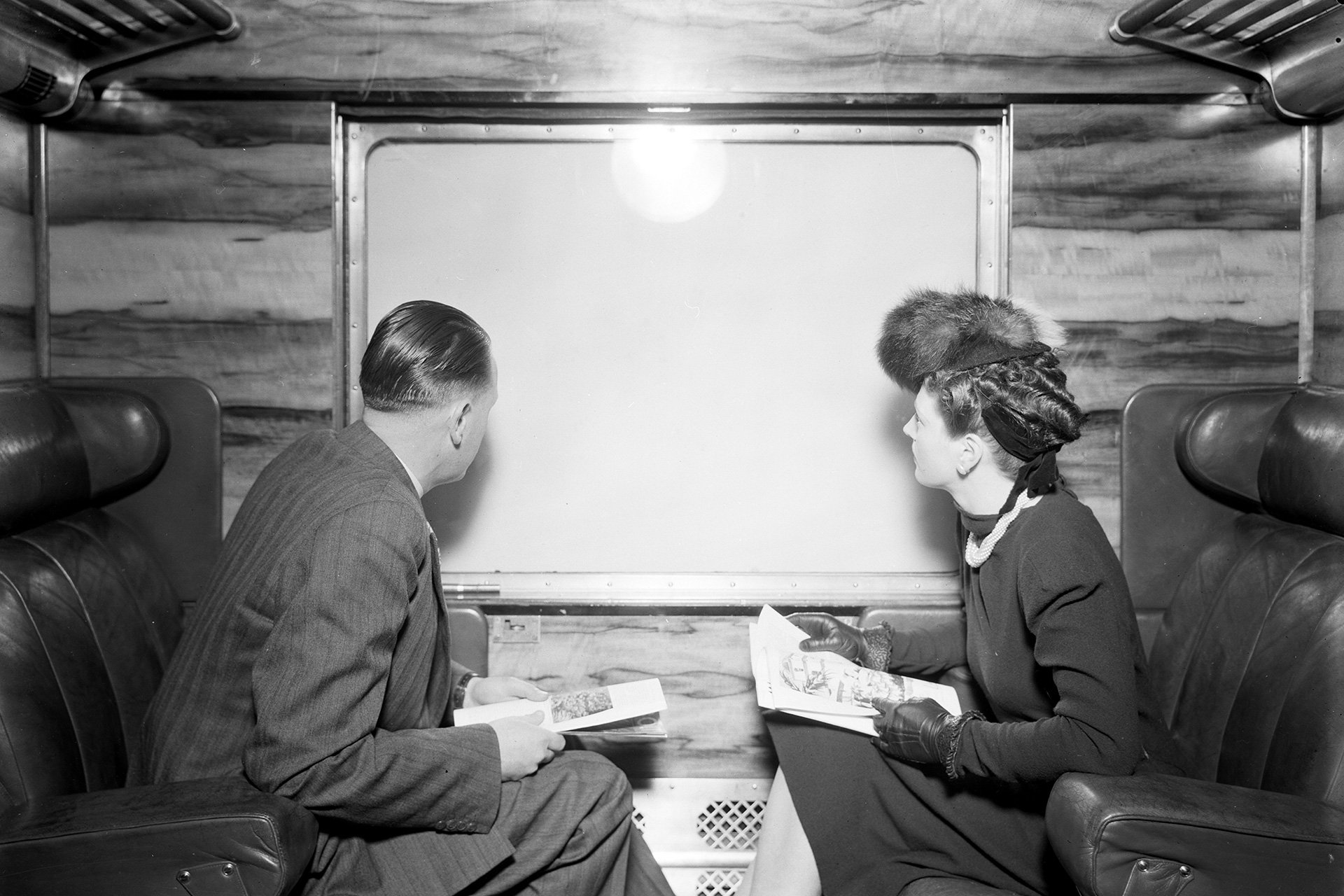 History Council Victoria Feb26 MAN AND WOMAN SEATED INSIDE PASSENGER CARRIAGE POSSIBLY SPIRIT OF PROGRESS
